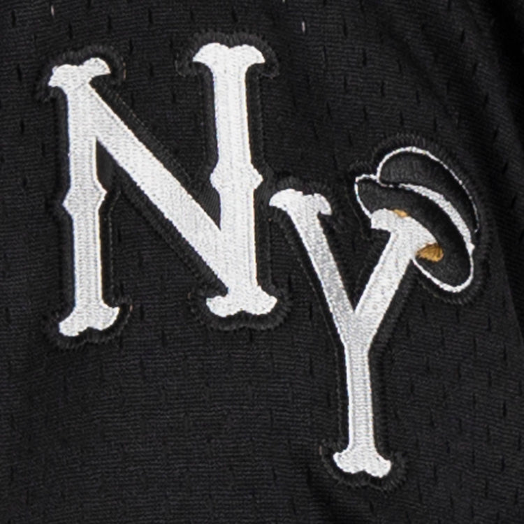 Close-up of the EFF New York Black Yankees Vintage Inspired NL Replica V-Neck Mesh Jersey in black, featuring white NY embroidery with a halo above the Y—a playful nod to the original Negro National League logo.