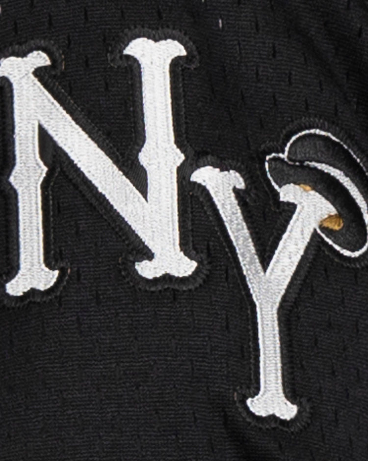 Close-up of the EFF New York Black Yankees Vintage Inspired NL Replica V-Neck Mesh Jersey in black, featuring white NY embroidery with a halo above the Y—a playful nod to the original Negro National League logo.