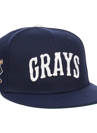 The EFF Homestead Grays NLB Flip Fitted Ballcap is a navy blue cap with GRAYS in bold white letters and a crossed bats “G” emblem, honoring the legendary Pittsburgh Homestead Grays.