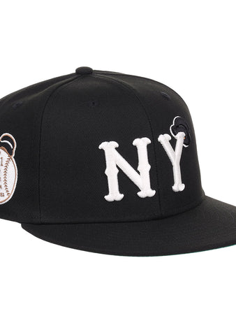 The EFF New York Black Yankees NLB Flip Fitted Ballcap features bold white NY letters, a black design, and a brown 1931 patch on the side honoring Negro National League heritage.