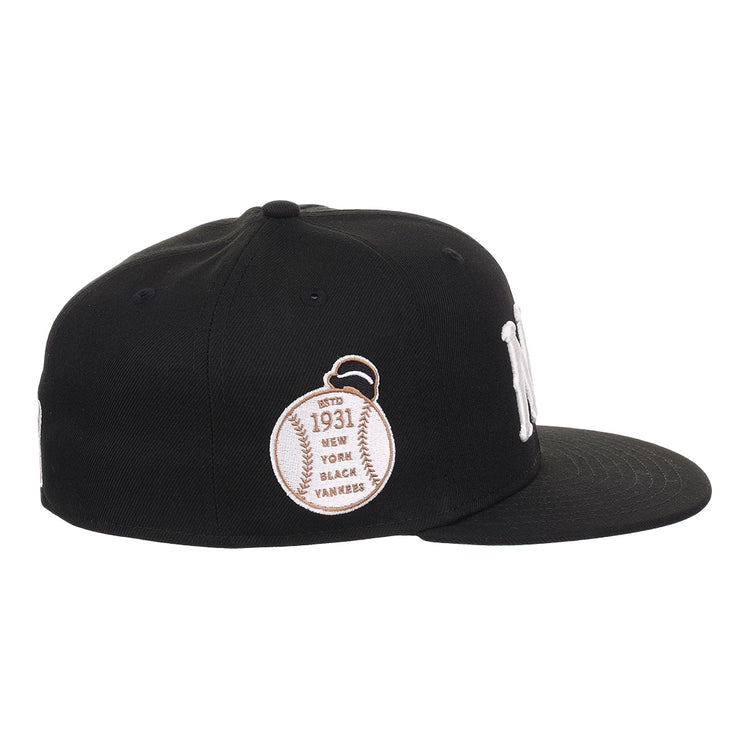 The EFF New York Black Yankees NLB Flip Fitted Ballcap is black with a white NY logo, a baseball patch reading Est. 1931, and New York Black Yankees embroidered on the side to honor the Negro National League. Flat brim design.