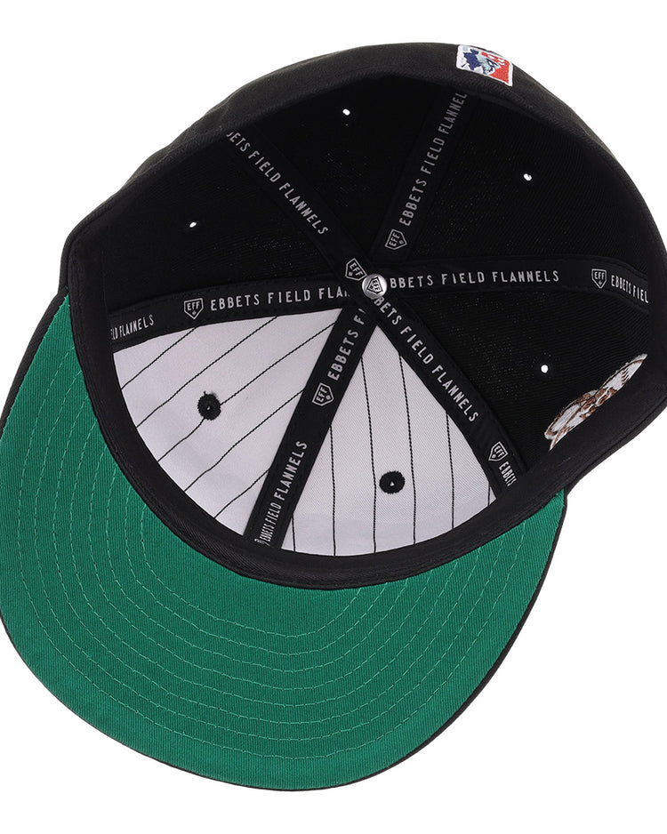 The New York Black Yankees NLB Flip Fitted Ballcap by EFF features a black crown, green brim, white pinstriped lining, and black bands labeled EBBETS FIELD FLANNELS. An MLB logo patch at the back honors the Negro National League legacy.