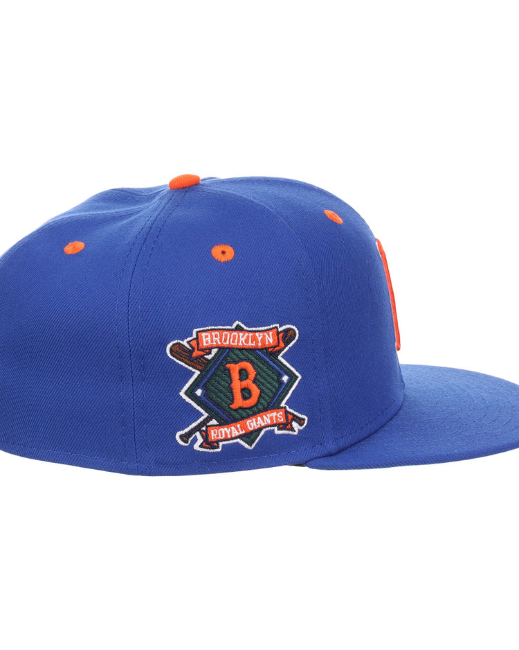 The EFF Brooklyn Royal Giants NLB Flip Fitted Ballcap is vintage-inspired in royal blue, with an orange top button and a 3D logo patch featuring a large B, two crossed bats, and Brooklyn Royal Giants.