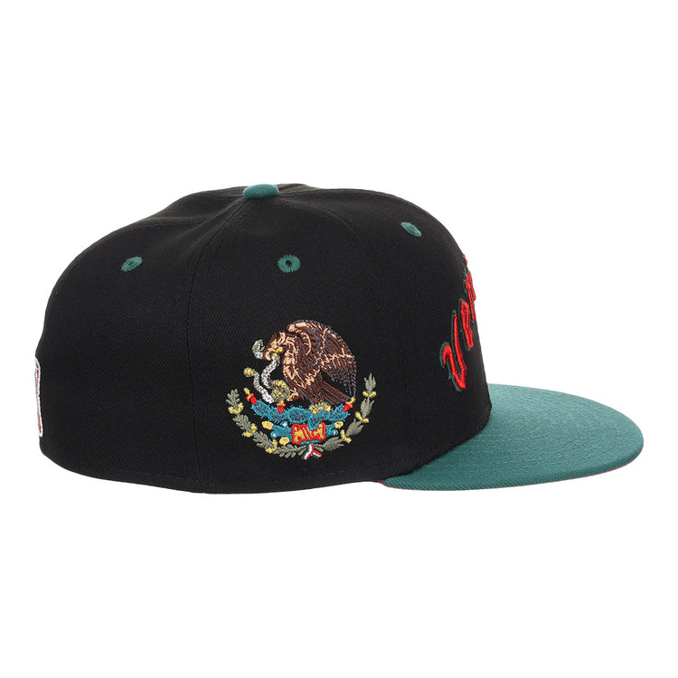 The EFF Veracruz Azules NLB Flip Fitted Ballcap is a black vintage-inspired cap with a green brim, bold red Mexican League lettering on the front, and an embroidered Mexican coat of arms on the side.