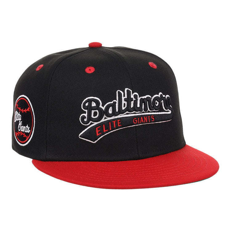 The EFF Baltimore Elite Giants NLB Flip Fitted Ballcap features black and red colors, a red bill and top button, front “Baltimore Elite Giants” embroidery, and a round Negro National League patch with a red baseball on the side.
