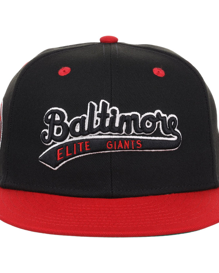 The EFF Baltimore Elite Giants NLB Flip Fitted Ballcap is a black vintage cap with a red brim, featuring Baltimore Elite Giants embroidered in white and red, honoring the storied Negro National League team.