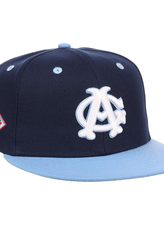 The EFF Chicago American Giants NLB Flip Fitted Ballcap is a navy blue, vintage-inspired hat with a light blue brim, featuring a white AC logo on the front and a red, white, and blue patch on the side.