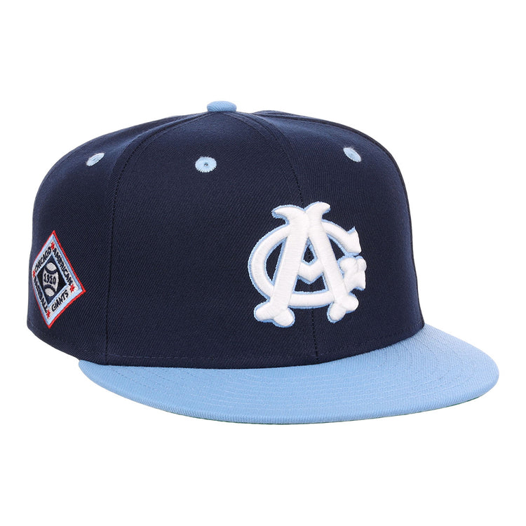 The EFF Chicago American Giants NLB Flip Fitted Ballcap is a navy blue, vintage-inspired hat with a light blue brim, featuring a white AC logo on the front and a red, white, and blue patch on the side.