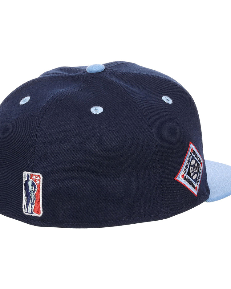 The EFF Chicago American Giants NLB Flip Fitted Ballcap is a navy cap with a light blue button and brim, vintage-inspired patches on back—a baseball player logo and diamond emblem—blending retro style with classic Negro League details.