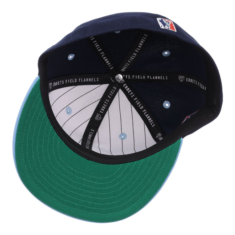 The inside of the Chicago American Giants NLB Flip Fitted Ballcap by EFF shows a navy cap with green underbill, black headband reading “EBBETS FIELD FLANNELS,” white pinstripe lining, and a stitched logo—perfect for fans.