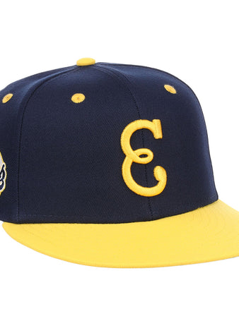 The EFF Newark Eagles NLB Flip Fitted Ballcap is navy blue and yellow with a yellow brim, features a large embroidered yellow C on the front, and has an American Eagles circular patch on the side.
