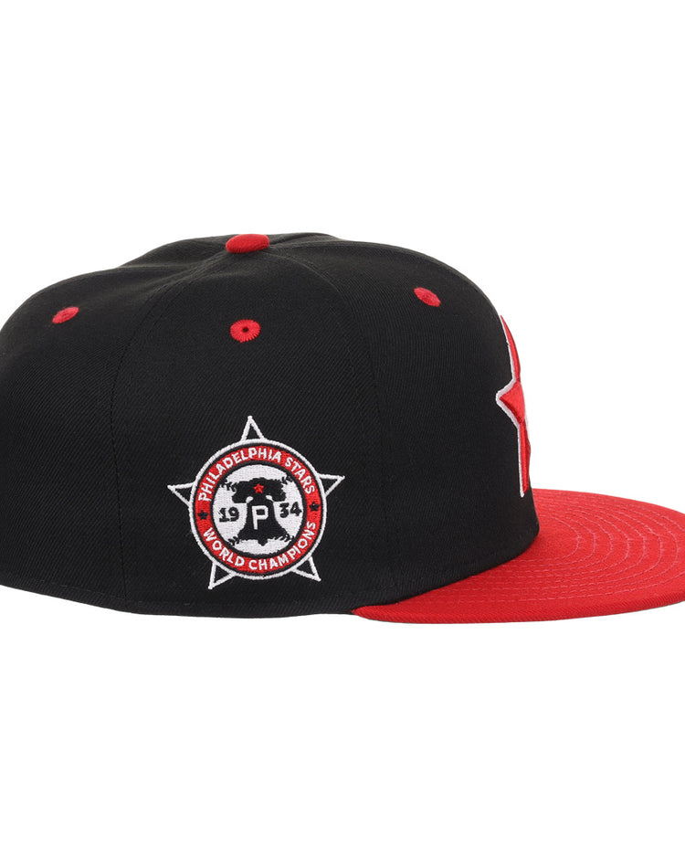 The EFF Philadelphia Stars NLB Flip Fitted Ballcap features a black and red design, flat red brim, and side patch reading Philadelphia Stars 1934 World Champions, honoring the Negro National League with a star and circle motif.