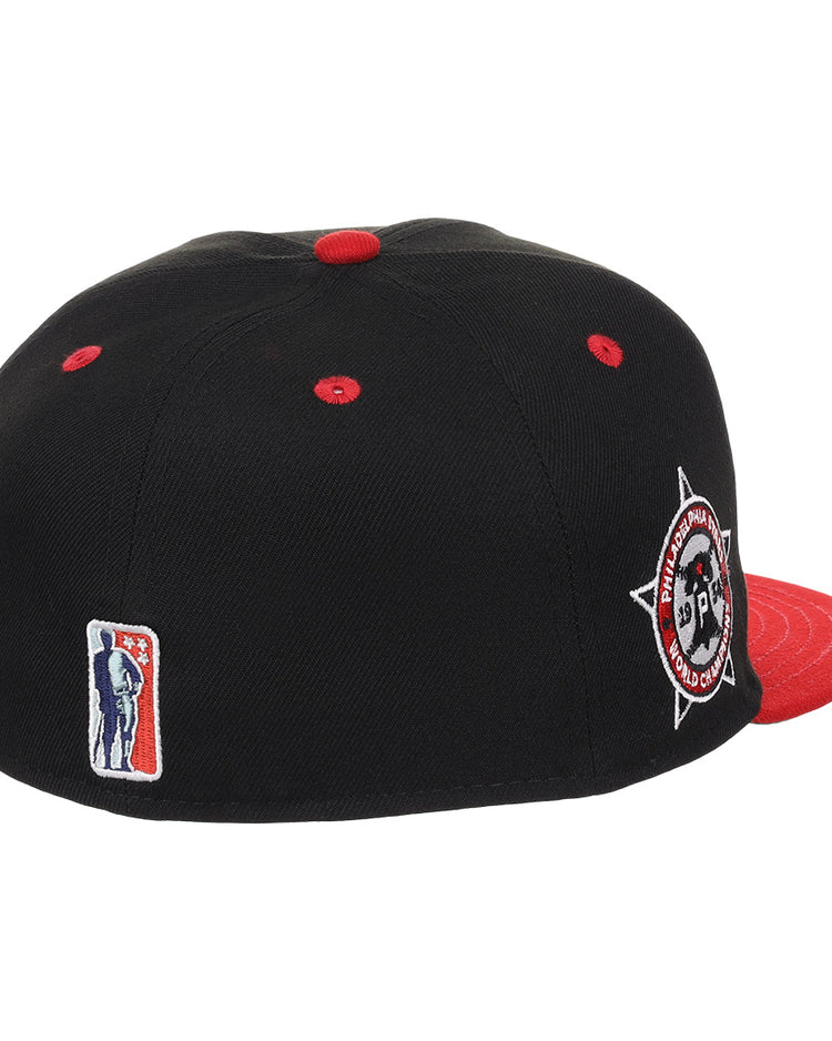 The EFF Philadelphia Stars NLB Flip Fitted Ballcap is black and red with a high crown, red brim, button, and eyelets. It features a circular embroidered side patch and a small Negro National League batter logo on the back.