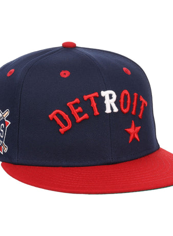 The EFF Detroit Stars NLB Flip Fitted Ballcap features a navy blue crown, red brim, DETROIT in red and white letters, a red star, and a Detroit Stars 1919 side patch—vintage style honoring the Negro National League.