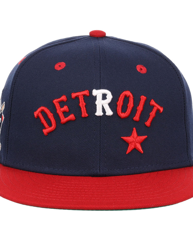 The EFF Detroit Stars NLB Flip Fitted Ballcap is a navy vintage-inspired cap with a red brim, DETROIT embroidered in red and white, and a red star on the front—a perfect tribute to the Detroit Stars.