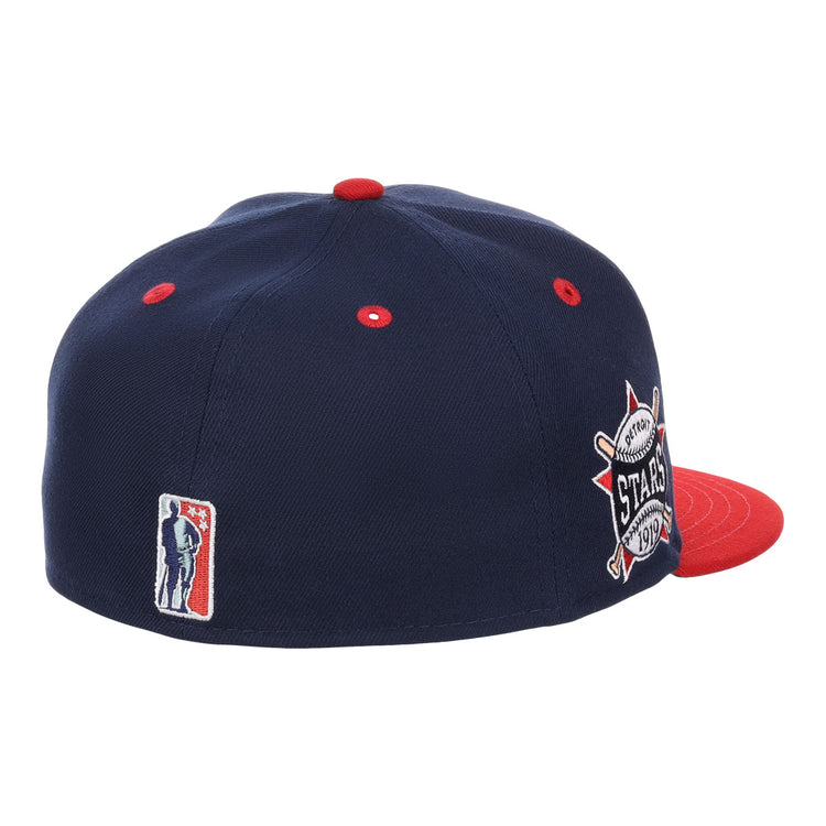 The EFF Detroit Stars NLB Flip Fitted Ballcap is a vintage-inspired navy cap with red eyelets and brim, featuring a 1974 All-Star Game patch on the side plus an embroidered silhouette logo on the back.