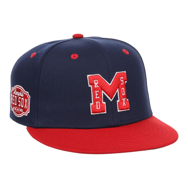 The EFF Memphis Red Sox NLB Flip Fitted Ballcap features a navy blue and red design, large red M with white outline, “RED SOX” on the front, a side Memphis Red Sox patch honoring the Negro American League team, plus a red bill and button.