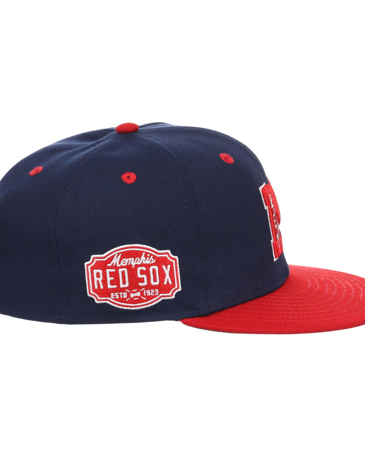 The EFF Memphis Red Sox NLB Flip Fitted Ballcap features navy blue and red colors, a red brim, a Memphis Red Sox side patch, and a bold red M front logo, honoring the Negro American Leagues legacy.