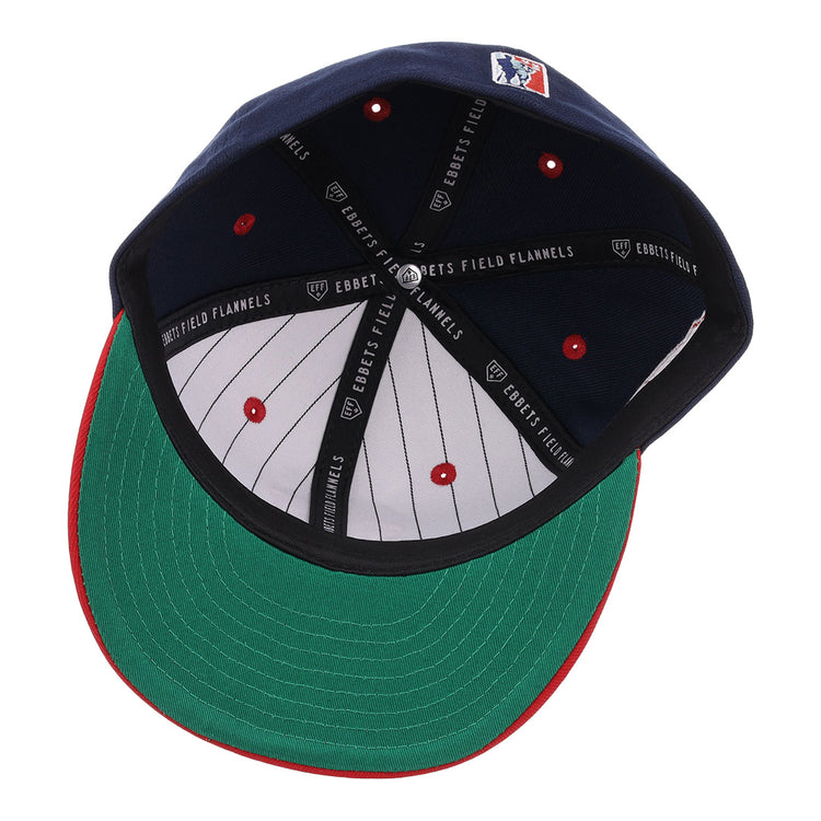 The EFF Memphis Red Sox NLB Flip Fitted Ballcap in navy features a green underbrim, red tip, white pinstripes inside, and “EBBETS FIELD FLANNELS” on the black inner band—a vintage-inspired classic.