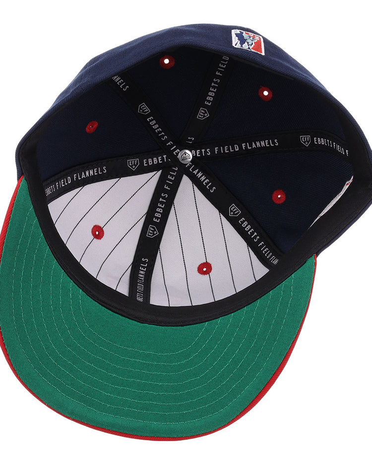 The EFF Memphis Red Sox NLB Flip Fitted Ballcap in navy features a green underbrim, red tip, white pinstripes inside, and “EBBETS FIELD FLANNELS” on the black inner band—a vintage-inspired classic.