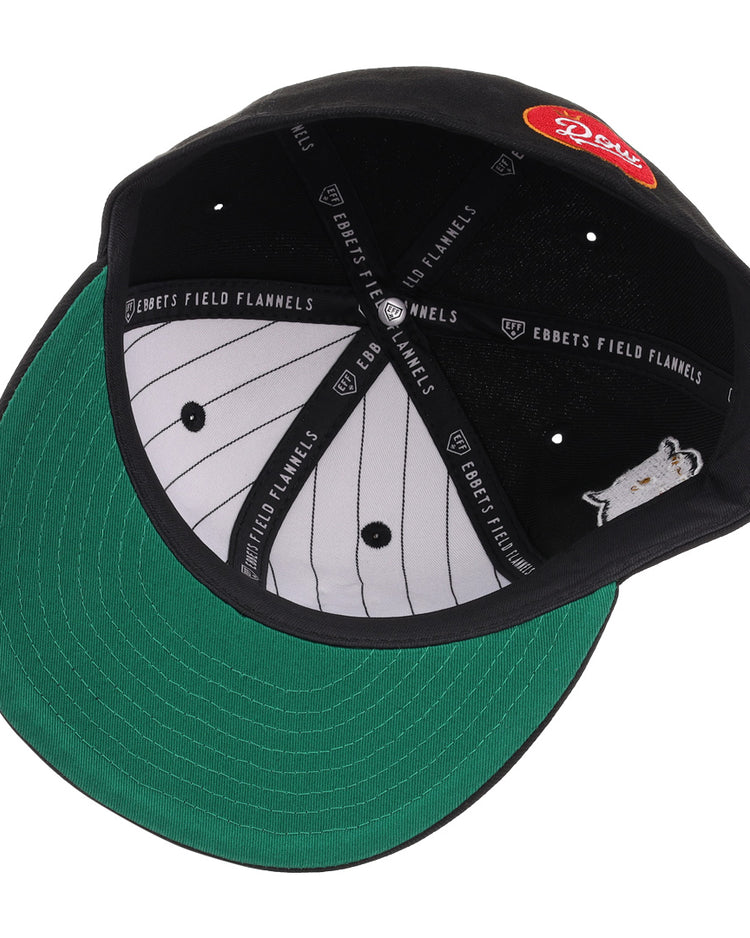 An overhead view of the EFF Montreal Black Panthers NLB Flip Fitted Ballcap—a black vintage-inspired hat with green underbrim, pinstriped white interior, EFF sweatband, and red logo patch reminiscent of Quebec Provincial League style.