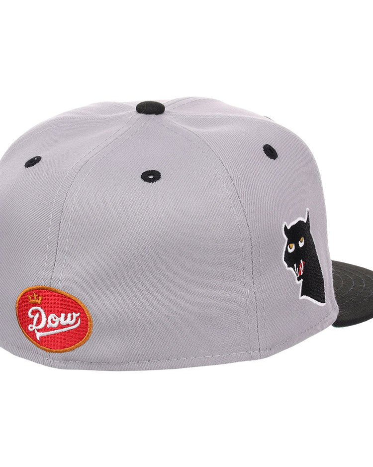 The EFF Montreal Black Panthers NLB Flip Fitted Ballcap in gray features a black brim, side panther head graphic, and a red oval Dow patch on the back, blending vintage inspiration with standout details.