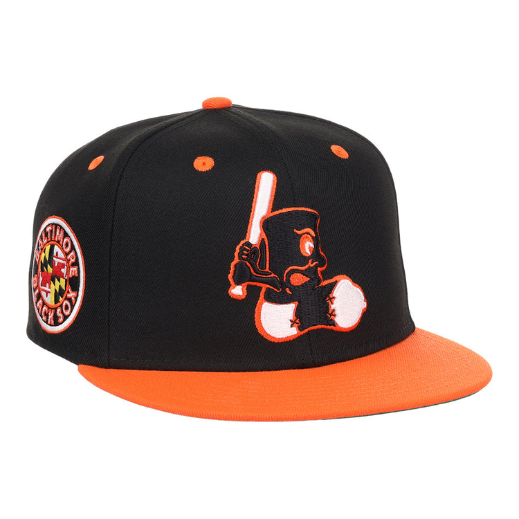 The EFF Baltimore Black Sox NLB Flip Fitted Ballcap features a vintage-inspired design with an embroidered cartoon bird, a side Baltimore Black Sox patch, and bold orange brim and button honoring the team’s Eastern Colored League legacy.
