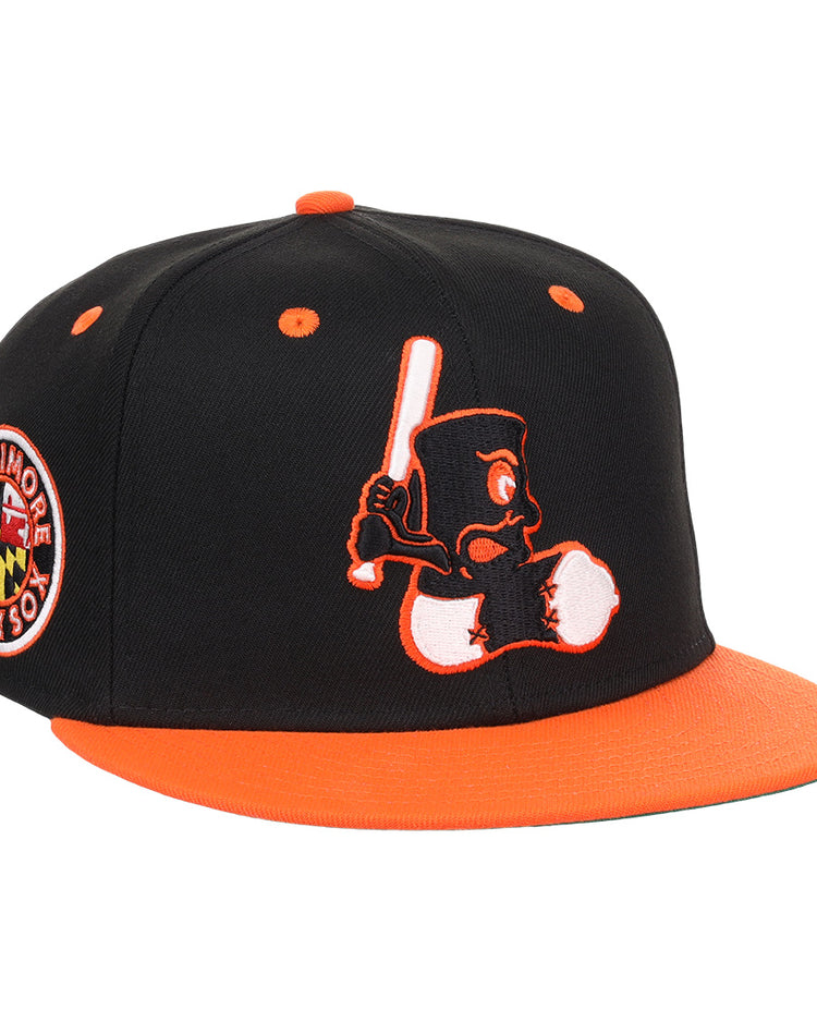 The EFF Baltimore Black Sox NLB Flip Fitted Ballcap features a vintage-inspired design with an embroidered cartoon bird, a side Baltimore Black Sox patch, and bold orange brim and button honoring the team’s Eastern Colored League legacy.