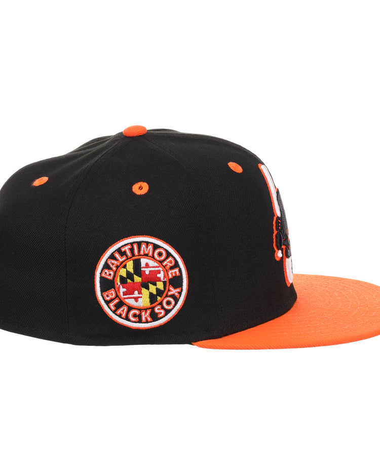 The EFF Baltimore Black Sox NLB Flip Fitted Ballcap features a black crown, orange brim and button, Maryland flag side patch, orange eyelets, Eastern Colored League embroidery, and vintage-inspired front detailing.