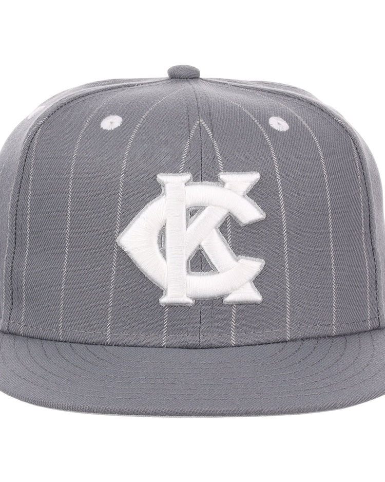 The EFF Kansas City Monarchs NLB Black Pinstripe Fitted Ballcap features black pinstripes, a flat brim, and a bold white KC logo inspired by the Monarchs Baseball Logo, celebrating Negro National League heritage.