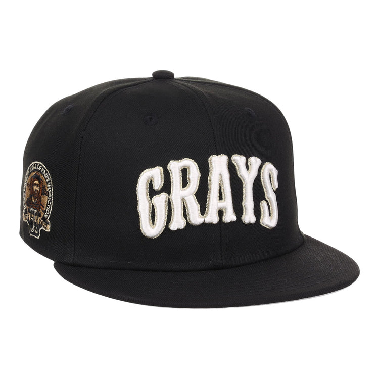The EFF Homestead Grays Josh Gibson Fitted Ballcap in black features bold white GRAYS lettering on the front and a small embroidered portrait patch with text on the left side.
