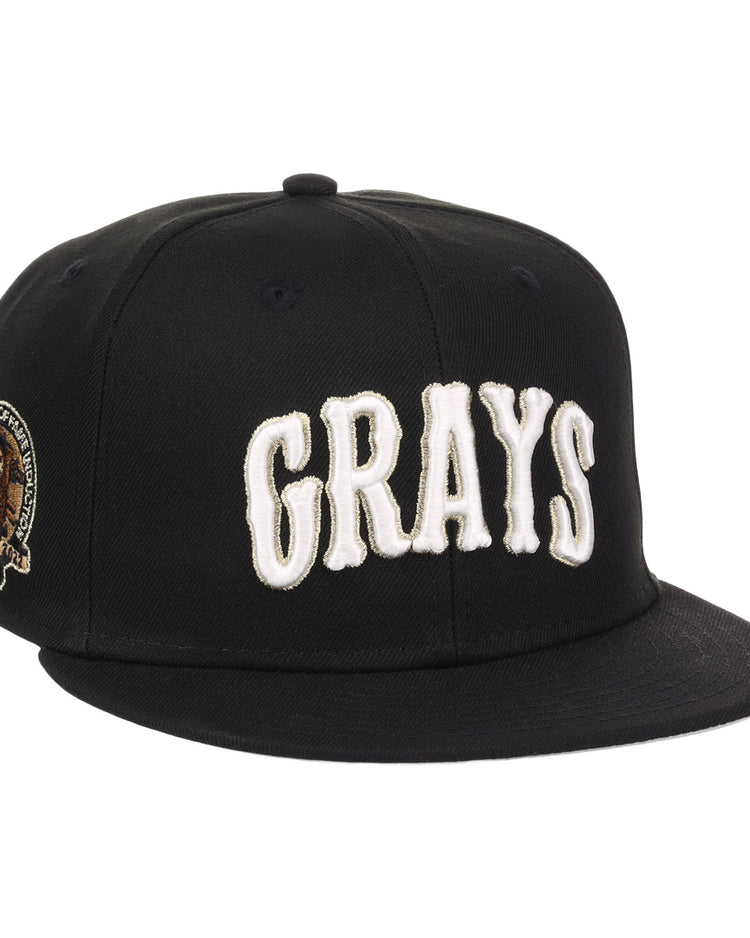 The EFF Homestead Grays Josh Gibson Fitted Ballcap in black features bold white GRAYS lettering on the front and a small embroidered portrait patch with text on the left side.