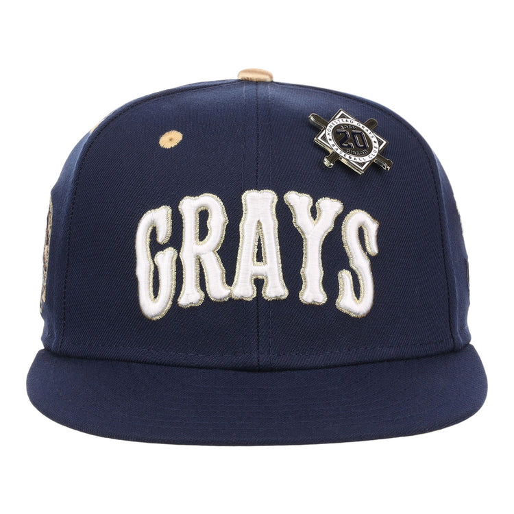 The EFF Homestead Grays Josh Gibson Fitted Ballcap in navy features bold white GRAYS lettering and a black and silver crossed bats pin, honoring baseball legends in this limited-edition design.