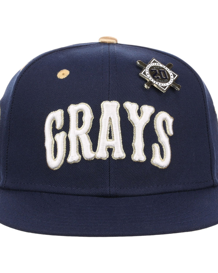 The EFF Homestead Grays Josh Gibson Fitted Ballcap in navy features bold white GRAYS lettering and a black and silver crossed bats pin, honoring baseball legends in this limited-edition design.
