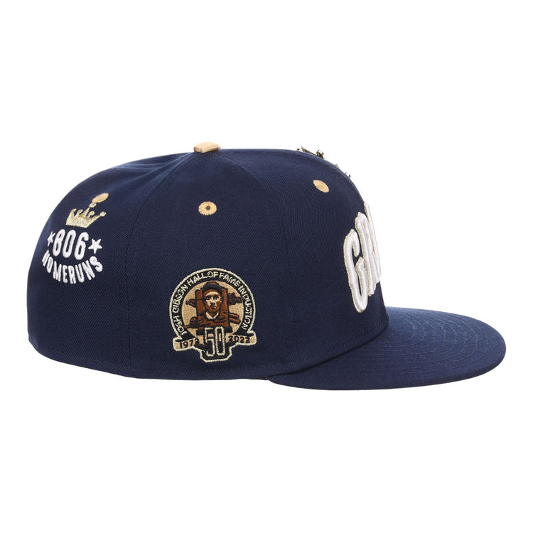 The EFF Homestead Grays Josh Gibson Fitted Ballcap in navy features 806 Home Runs with a crown graphic, a 50th Hall of Fame patch, and bold white embroidery, honoring Negro Leagues legend Josh Gibson. Limited edition.
