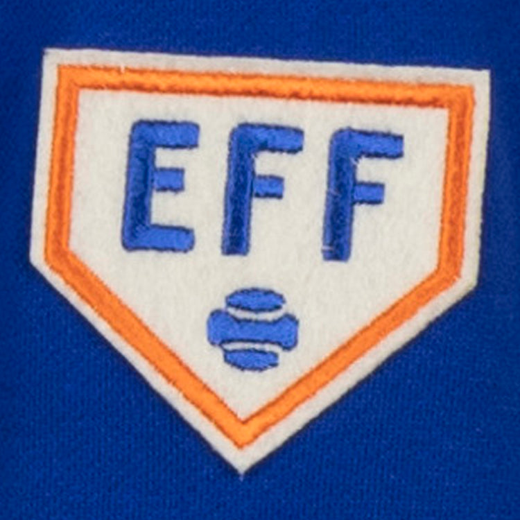 The Ebbets Field Flannels French Terry Script Hooded Sweatshirt by EFF features a patch with blue EFF lettering on a white home plate, orange outline, and two blue baseballs—ideal for fans of authentic historical sportswear.