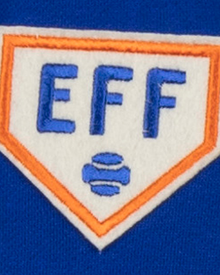 The Ebbets Field Flannels French Terry Script Hooded Sweatshirt by EFF features a patch with blue EFF lettering on a white home plate, orange outline, and two blue baseballs—ideal for fans of authentic historical sportswear.