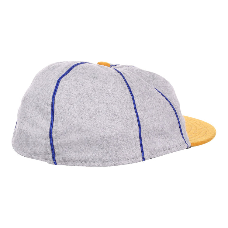 The EFF Pasadena Merchants 1919 Vintage 8-Panel Ballcap features a grey wool finish, blue stitching, and a yellow brim. Inspired by classic California Winter League styles, it’s shown here from a side and rear angle.