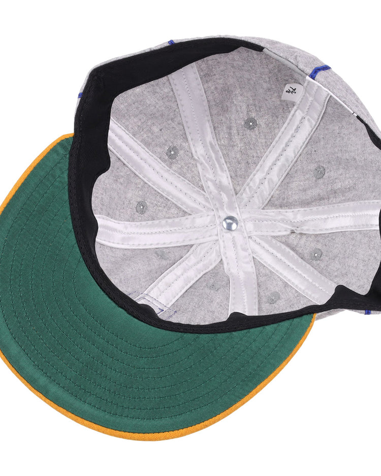 The underside of the EFF Pasadena Merchants 1919 Vintage 8-Panel Ballcap features a green brim with yellow edge, gray interior panels, white stitching, and a top-center button—echoing classic California Winter League style.