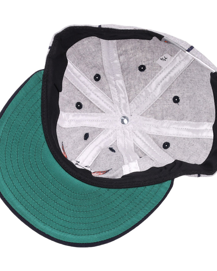 The image shows the inside of an EFF Columbia Park 1909 Vintage 8-Panel Ballcap with a green brim, gray lining, black sweatband, visible stitching, and ventilation holes. The cap is laid flat with the brim facing left.
