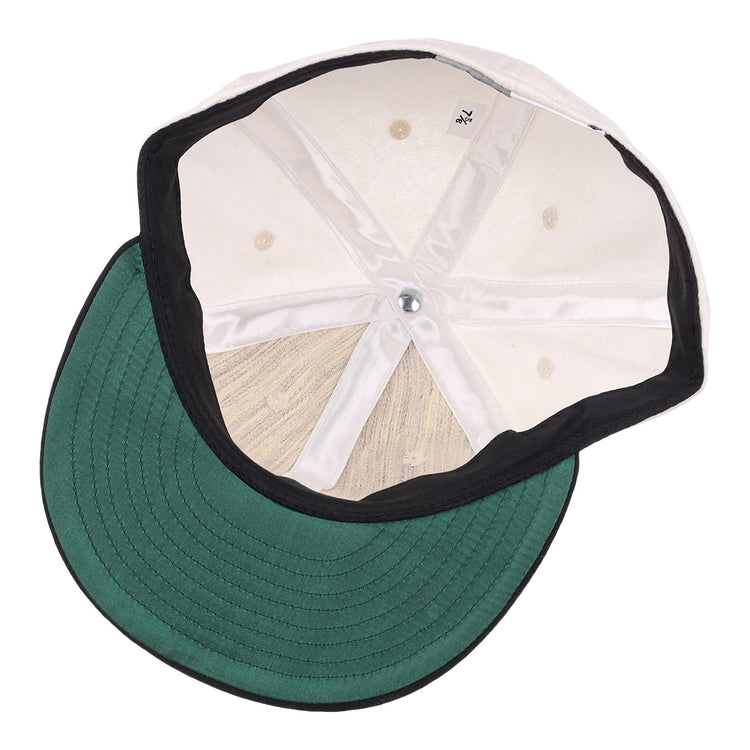 An inside view of the EFF Thespians 1919 Vintage Ballcap: features a green brim, white stitched inner panels, and a black sweatband—an authentic reproduction of a classic baseball cap.