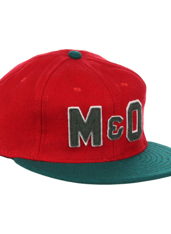The EFF M&O Cigars 1946 Vintage Ballcap is a red wool cap with a dark green brim, small green top button, and large gray “M&O” embroidery on the front, inspired by the classic 1946 original.