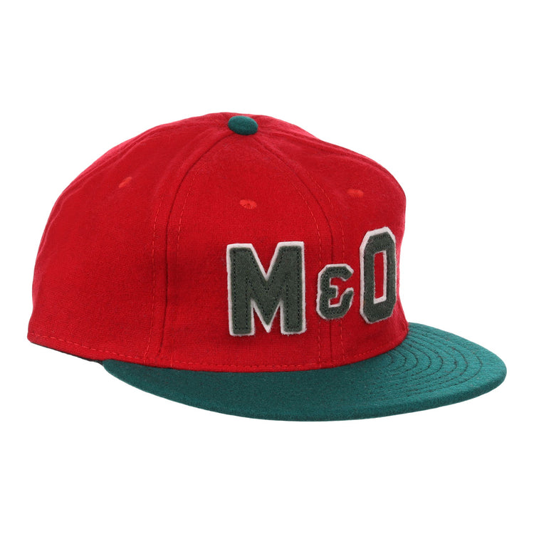 The EFF M&O Cigars 1946 Vintage Ballcap is a red wool cap with a dark green brim, small green top button, and large gray “M&O” embroidery on the front, inspired by the classic 1946 original.