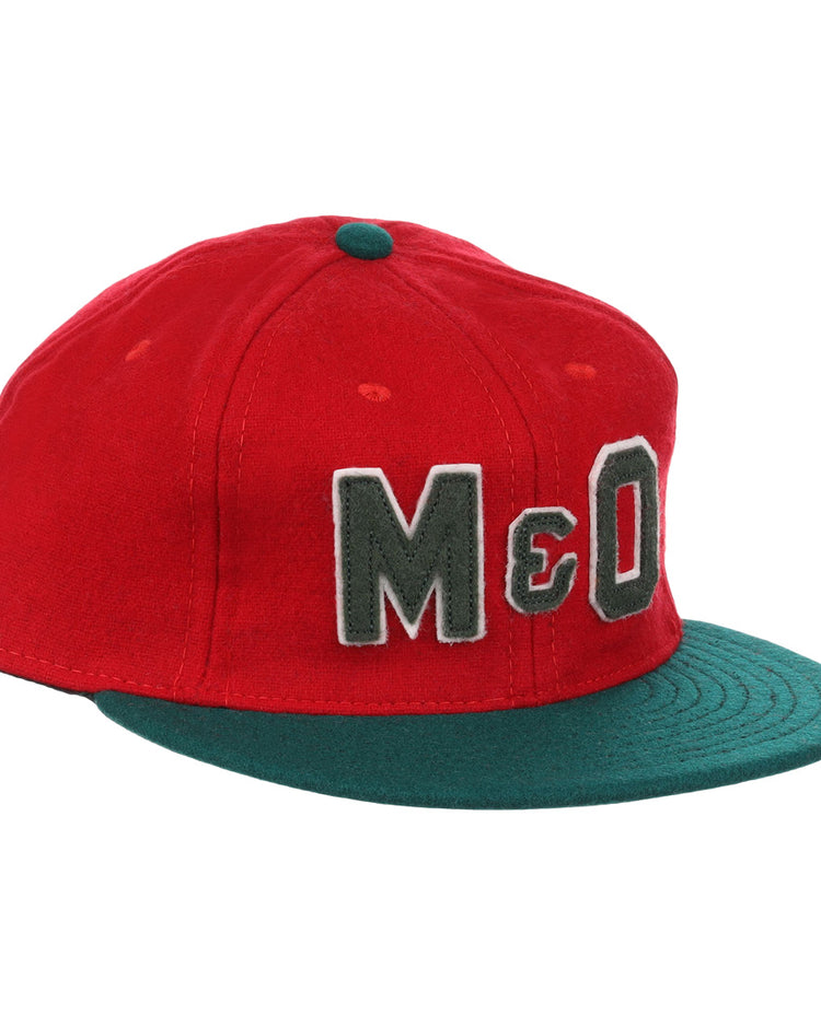 The EFF M&O Cigars 1946 Vintage Ballcap is a red wool cap with a dark green brim, small green top button, and large gray “M&O” embroidery on the front, inspired by the classic 1946 original.