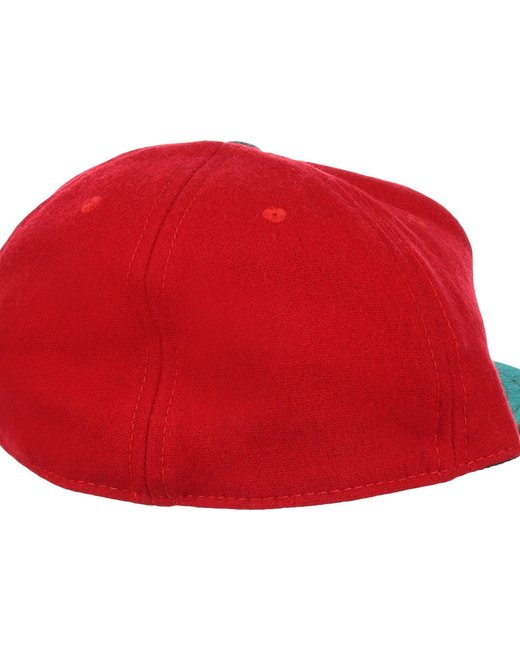 The M&O Cigars 1946 Vintage Ballcap by EFF is a red cap shown from the back, with a teal brim partially visible on the right. Its soft fabric and visible stitching evoke timeless, classic style.