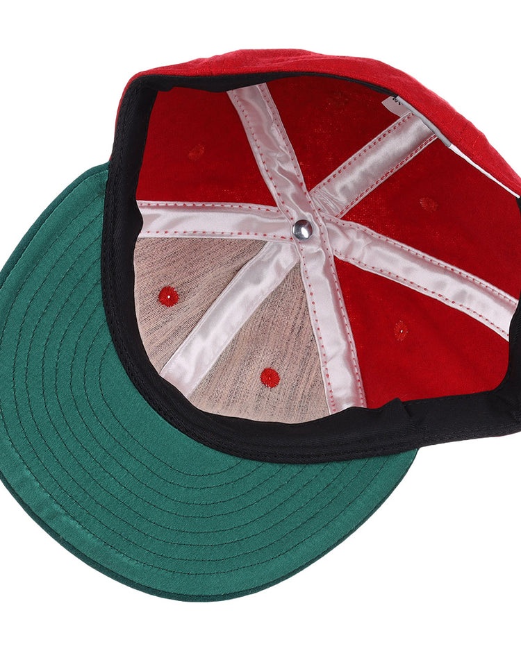 A top-down view of the EFF M&O Cigars 1946 Vintage Ballcap reveals white stitched panels, a green brim, red ventilation holes, and a silver center button.