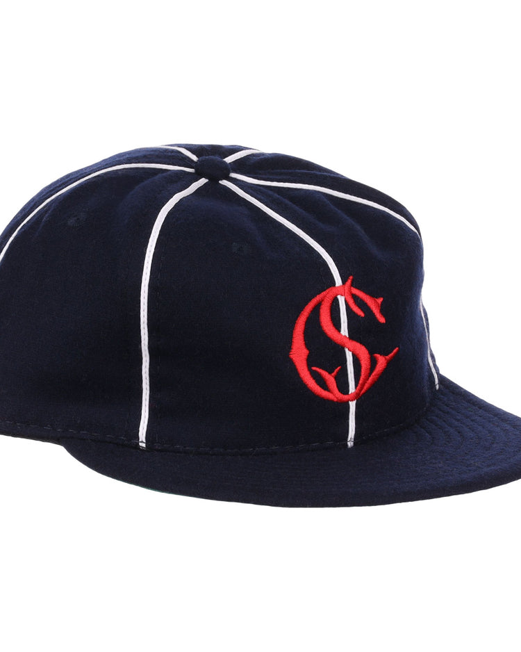 The EFF Santa Cruz Crabs 1908 Vintage Ballcap features navy blue wool with white stripes and a red interlocking “C” and “S” logo on the front, offering a timeless, classic baseball style.
