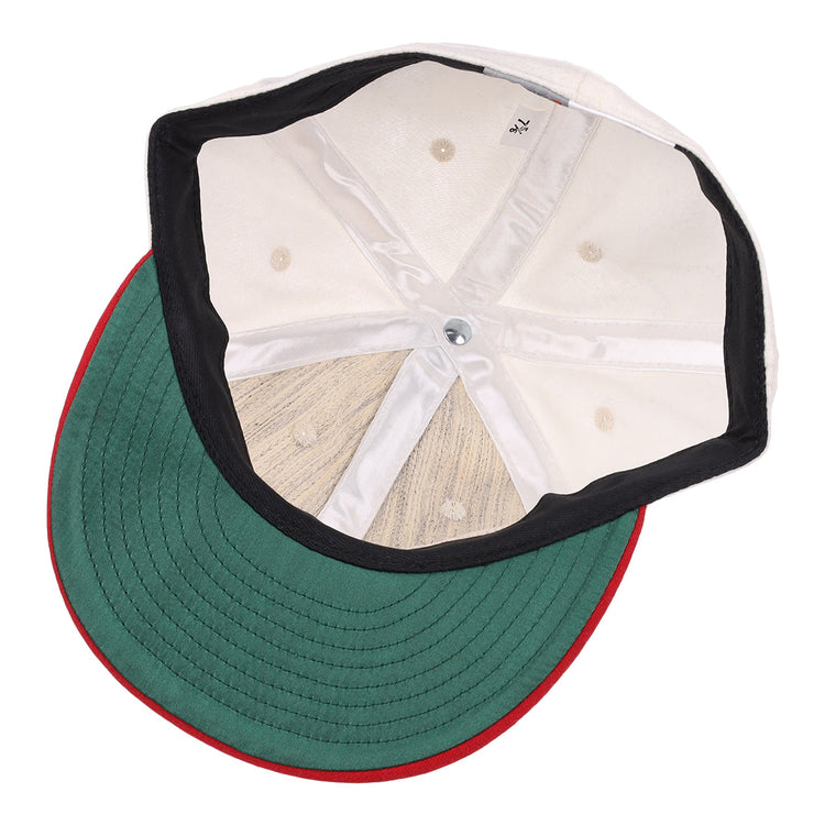 The image shows the inside of the EFF Nebraska State Prison 1923 Vintage Ballcap, featuring visible inner seams, a green brim with red edge, and a silver top button for an authentic reproduction look.