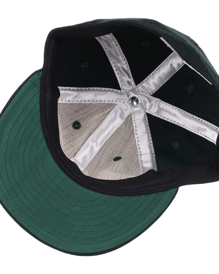 A look inside the EFF Brooklyn Manhattan Transit Company 1939 Vintage Ballcap reveals its green flat brim, black inner band, silver lining strips, and visible stitching.