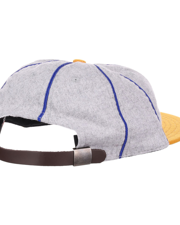 The EFF Pasadena Merchants 1919 Vintage 8-Panel Ballcap is a wool cap in gray with blue stitching, a yellow brim, and a brown adjustable strap with metallic clasp—shown from the rear, evoking classic California Winter League style.